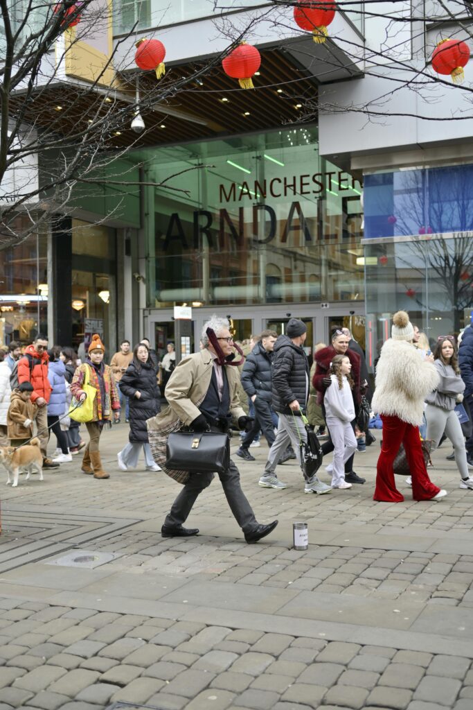 People walking and shopping outside Manchester Arndale Center.