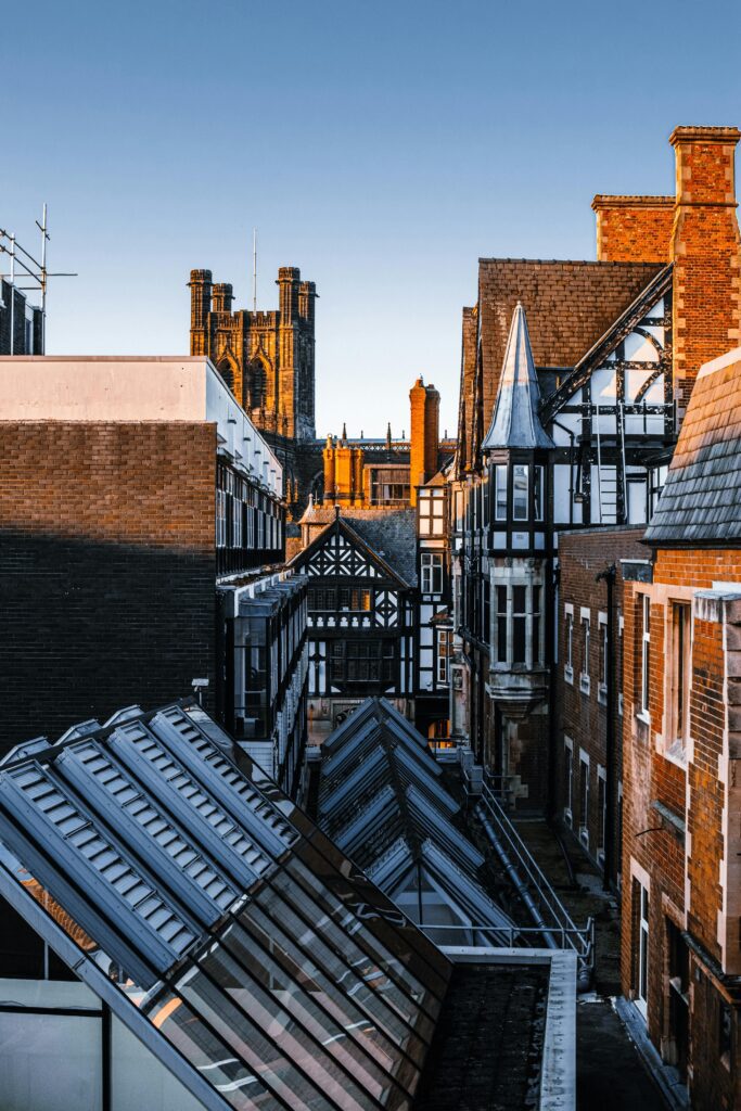 Scenic view of Chester's Tudor-style buildings and cityscape at sunset.