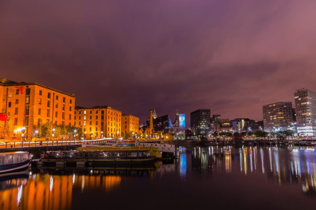 Stunning view of Liverpool's Albert Dock with cityscape reflections at dusk.
