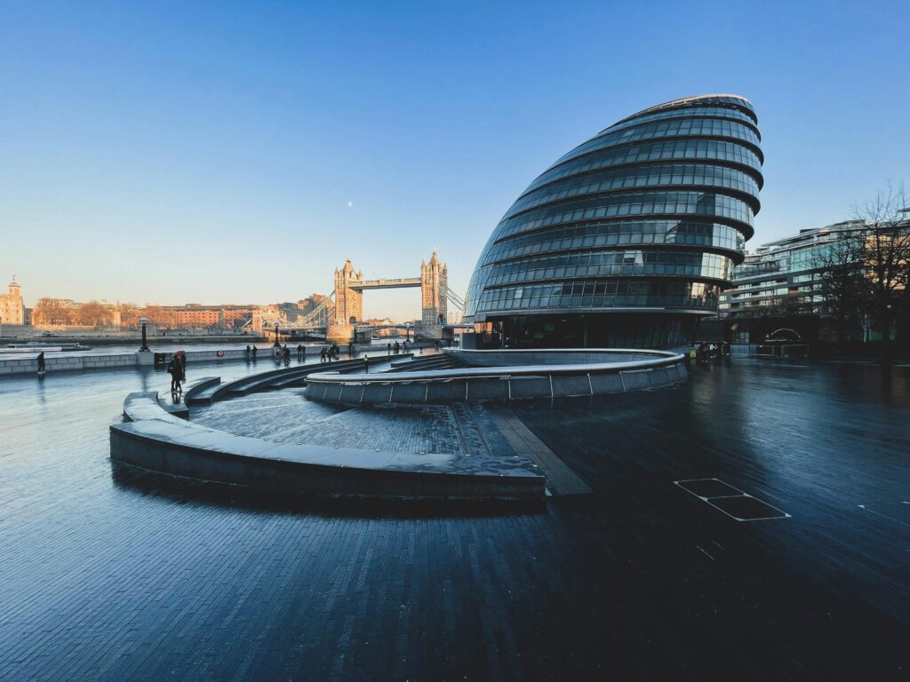 Dynamic view of London's modern architecture and iconic Tower Bridge.
