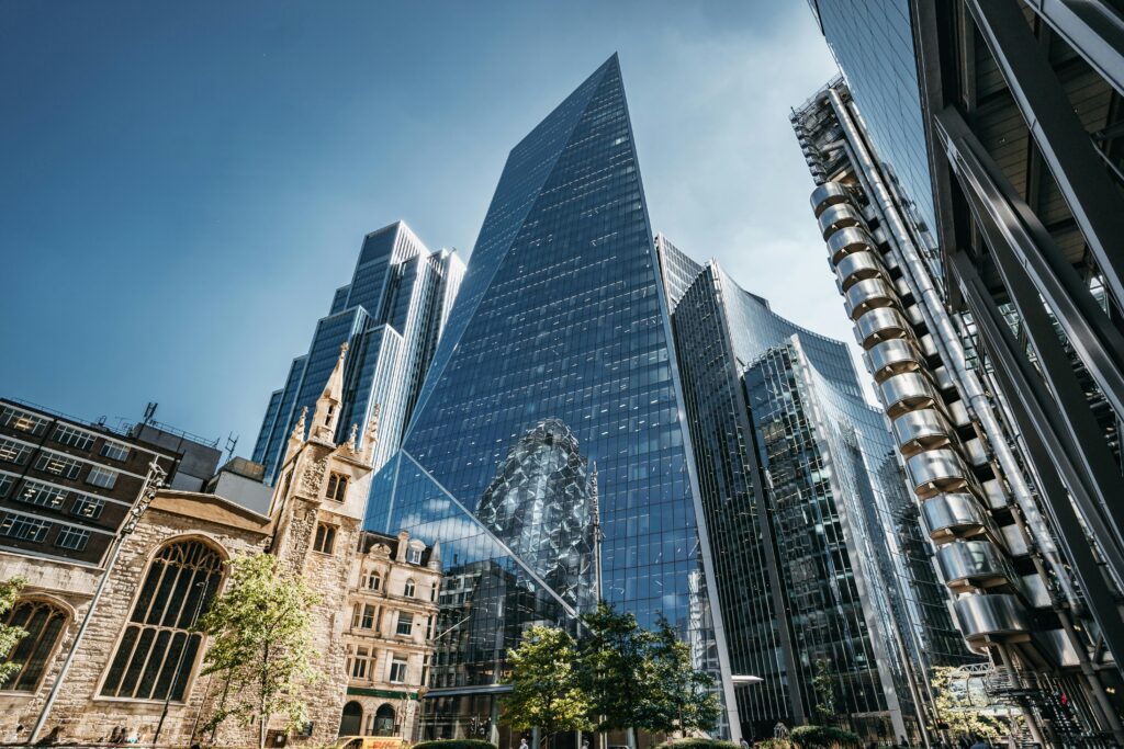 A striking view of London's modern skyline, featuring The Scalpel skyscraper against a clear blue sky.