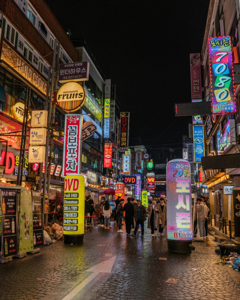 Bustling Seoul street scene with neon signs and people exploring Korea's vibrant nightlife.