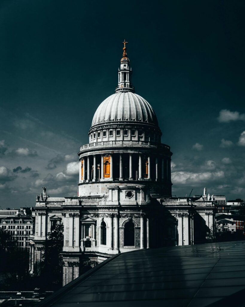 A striking view of St Paul's Cathedral under a dramatic sky in London.