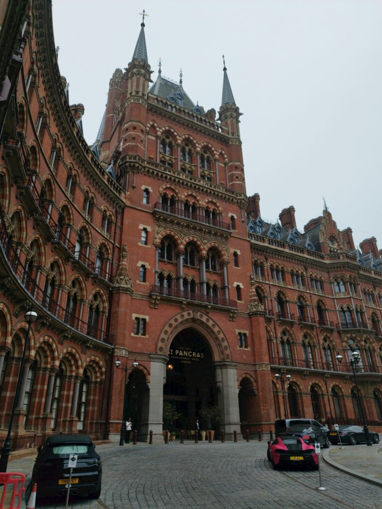 St Pancras Station in London showcasing Gothic Revival architecture on a cloudy day.