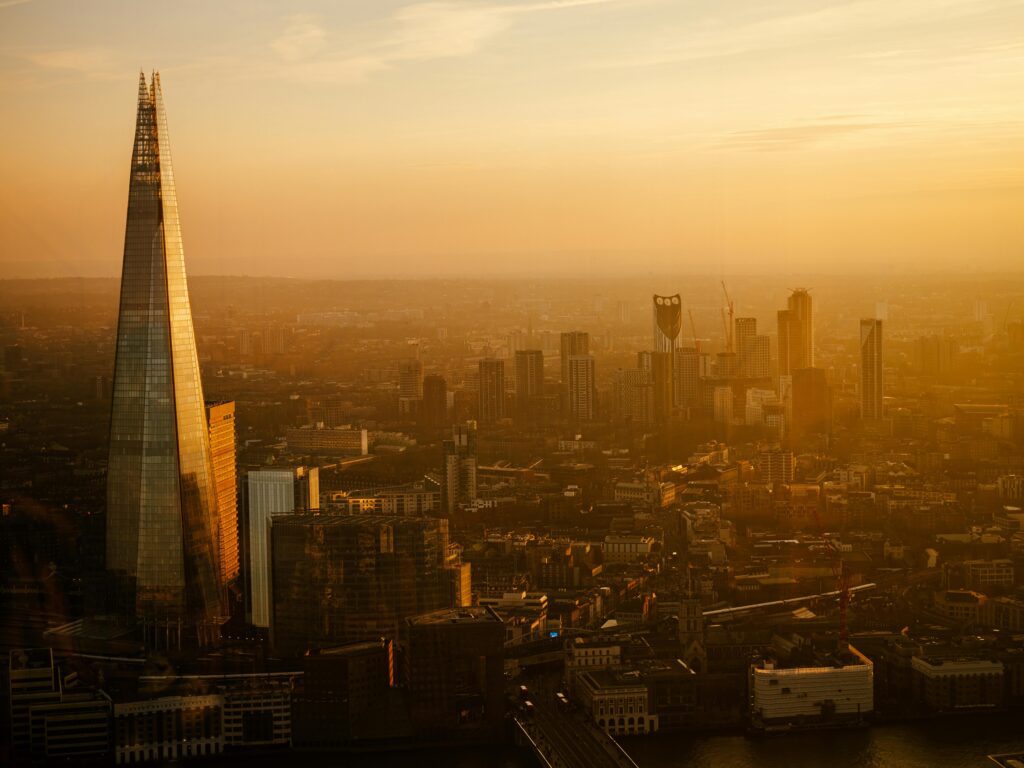 A panoramic view of London's skyline during sunset, highlighting The Shard.